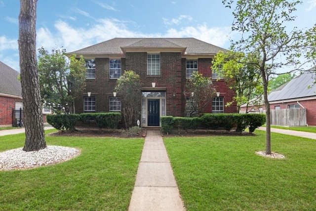 16918 Ascot Meadow Dr, Sugar Land, TX 77479 - view of front of home with fence, a front lawn, and brick siding