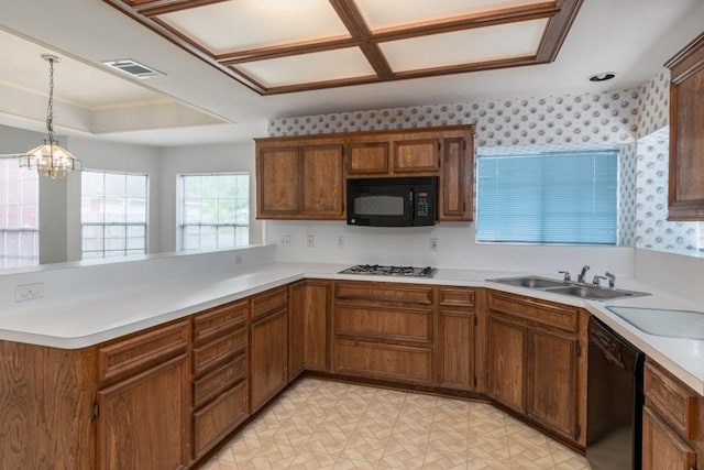 16918 Ascot Meadow Dr, Sugar Land, TX 77479 - kitchen featuring wallpapered walls, a peninsula, black appliances, visible vents, and a sink