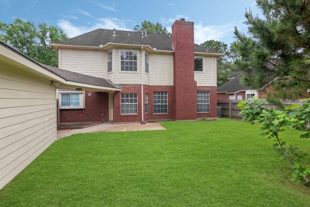 16918 Ascot Meadow Dr, Sugar Land, TX 77479 - rear view of house featuring a chimney, a patio area, brick siding, fence, and a lawn