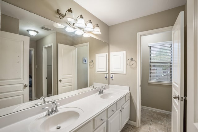 11826 Thoreau Dr, Montgomery, TX 77356 - bathroom featuring visible vents, a sink, baseboards, and double vanity