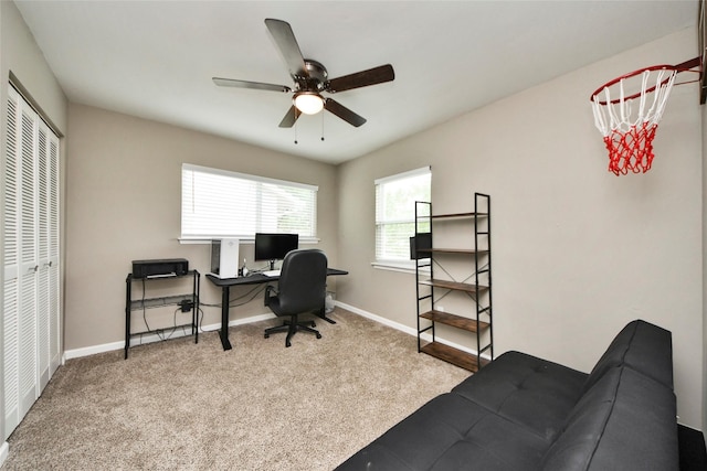 carpeted office with baseboards and ceiling fan