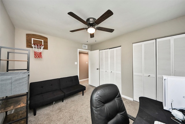 carpeted office with a ceiling fan, baseboards, and visible vents