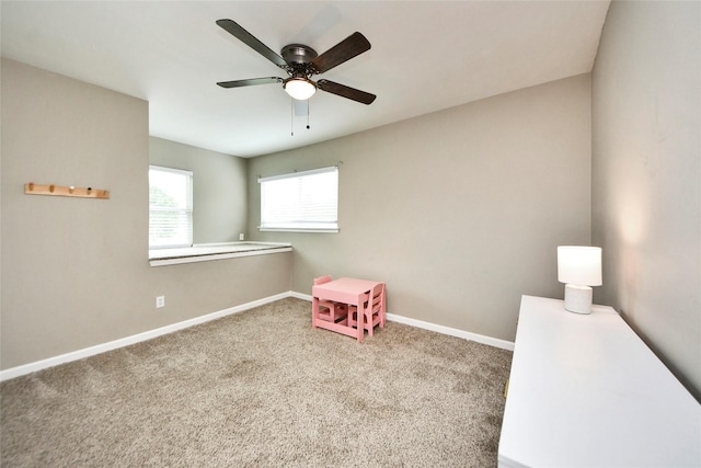recreation room with baseboards, a ceiling fan, and carpet