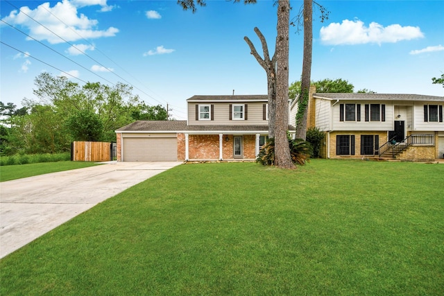 raised ranch with a garage, fence, a front yard, brick siding, and concrete driveway
