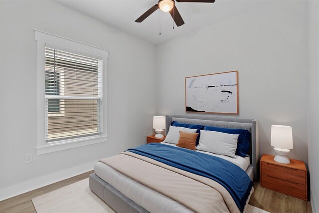416 13th St, San Leon, TX 77539 - bedroom with wood finished floors, baseboards, and ceiling fan