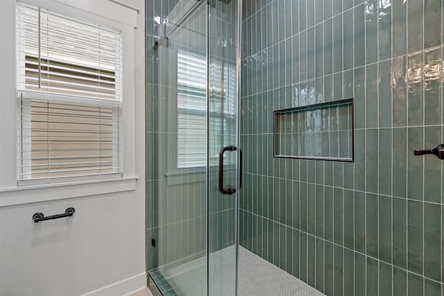 416 13th St, San Leon, TX 77539 - bathroom featuring a shower stall, baseboards, and healthy amount of natural light