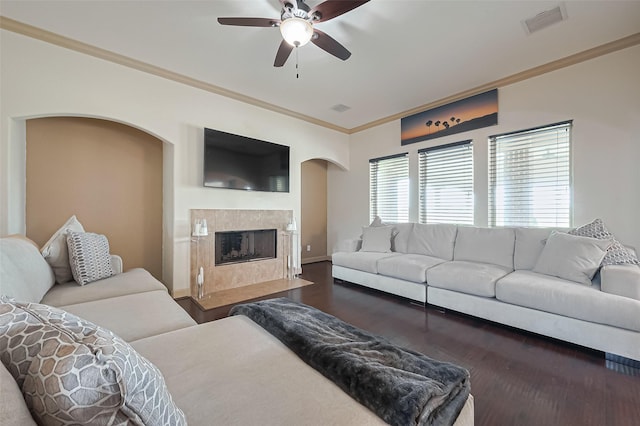 living room featuring ornamental molding, dark wood-type flooring, ceiling fan, and visible vents