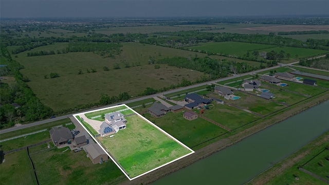 drone / aerial view featuring a water view and a rural view
