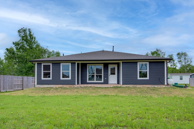 6714 Scott St, Liverpool, TX 77577 - ranch-style house featuring roof with shingles, fence, and a front lawn