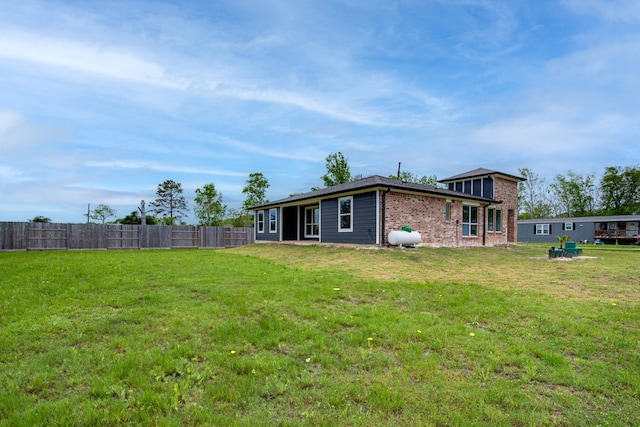 6714 Scott St, Liverpool, TX 77577 - back of house featuring a yard, brick siding, and fence
