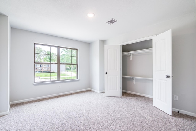 6714 Scott St, Liverpool, TX 77577 - unfurnished bedroom featuring a closet, carpet, visible vents, and baseboards