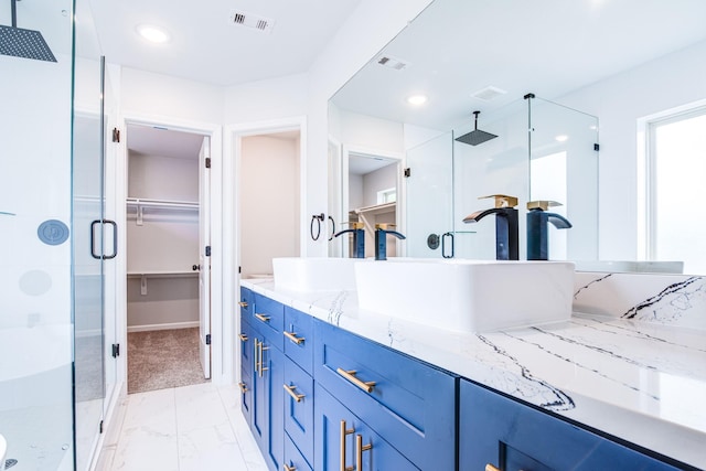 6714 Scott St, Liverpool, TX 77577 - full bathroom with a spacious closet, visible vents, double vanity, and a stall shower
