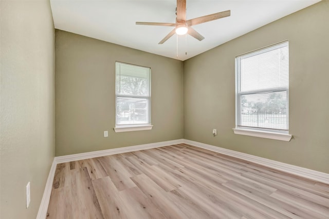 empty room with baseboards, light wood-type flooring, and ceiling fan