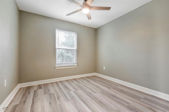 unfurnished room featuring a ceiling fan, baseboards, and light wood finished floors