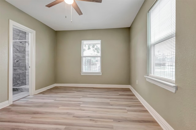 empty room featuring baseboards, light wood-style floors, and a ceiling fan