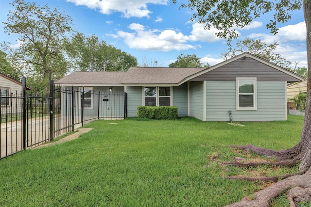 ranch-style home with a front yard, fence, and roof with shingles