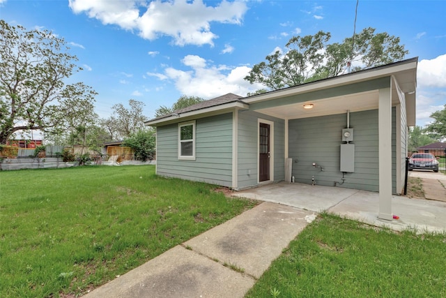 back of property featuring a lawn
