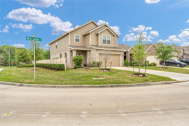 craftsman-style house with concrete driveway, a front lawn, brick siding, and a garage