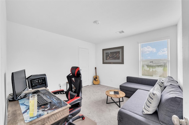 carpeted office featuring visible vents and baseboards