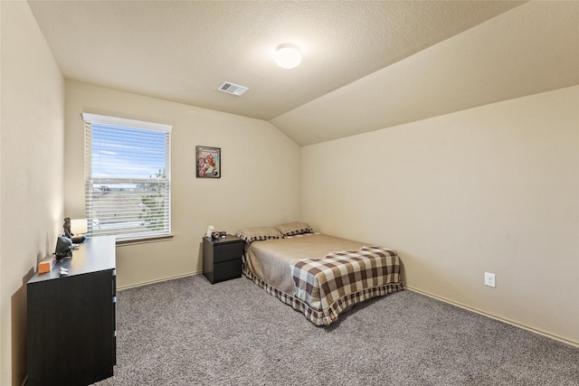 bedroom with carpet flooring, a textured ceiling, visible vents, baseboards, and lofted ceiling