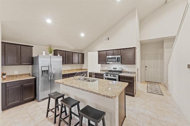 kitchen featuring a sink, dark brown cabinets, appliances with stainless steel finishes, and visible vents