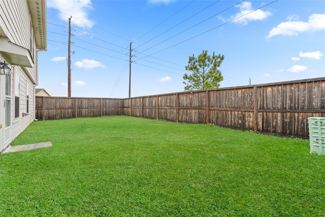 view of yard with a fenced backyard