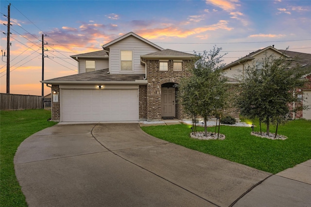 traditional home with a lawn, brick siding, fence, and concrete driveway