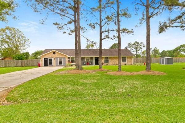 1760 County Road 965, Alvin, TX 77511 - ranch-style home with a shed, an outdoor structure, and driveway