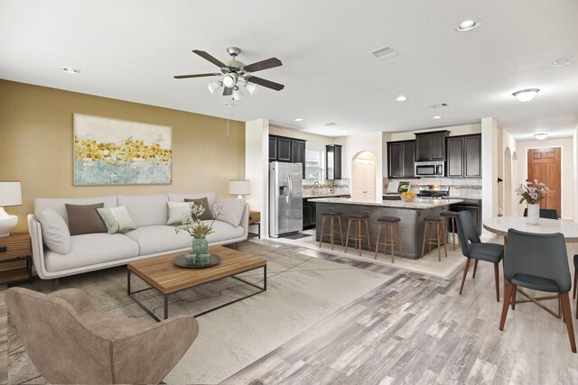 2311 Leonetti Ln, Rosenberg, TX 77471 - living area with light wood finished floors, a ceiling fan, and recessed lighting