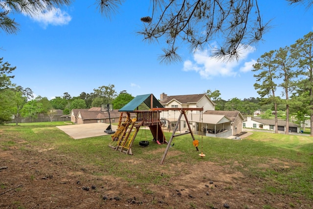 view of jungle gym featuring fence and a lawn