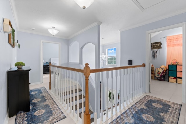 hallway featuring ornamental molding, tile patterned flooring, and an upstairs landing