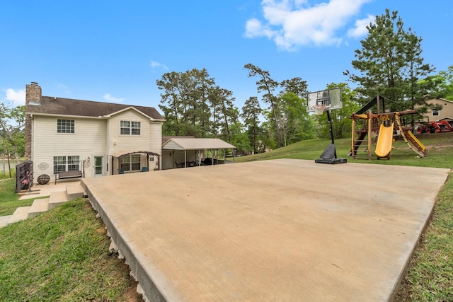 exterior space with driveway, a playground, and a carport