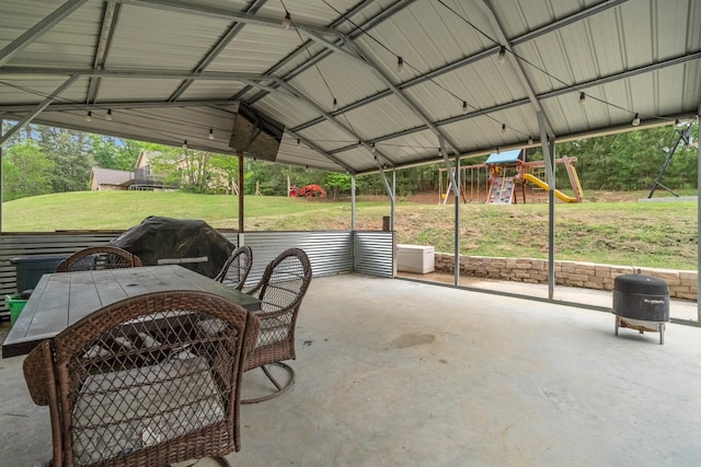view of patio featuring a playground and outdoor dining space