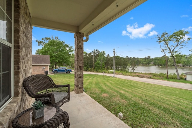 view of patio with a water view