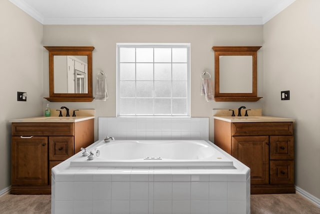 bathroom featuring a sink, ornamental molding, two vanities, and a garden tub