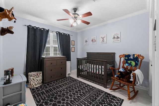 bedroom with a crib, ornamental molding, and a textured ceiling