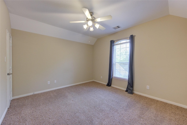 unfurnished room with ceiling fan, vaulted ceiling, visible vents, carpet floors, and baseboards