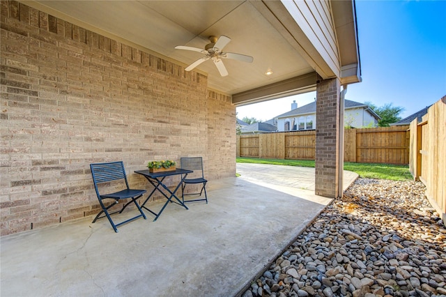 view of patio featuring outdoor dining area, a fenced backyard, and ceiling fan