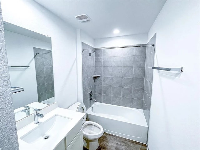 bathroom featuring visible vents, toilet, vanity, and shower / bath combination