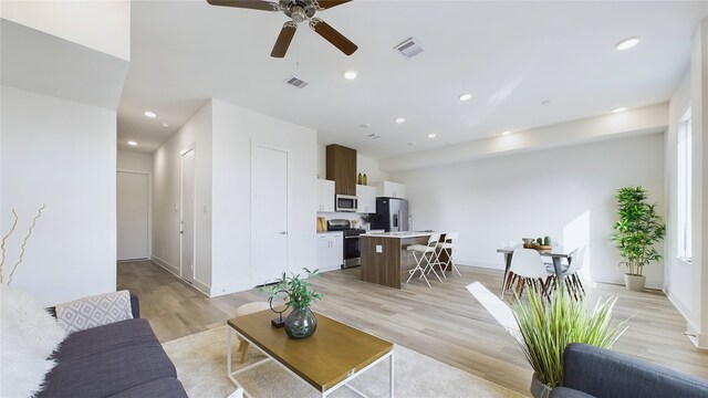 9616 Habitat St, Houston, TX 77075 - living room with recessed lighting, light wood finished floors, visible vents, a ceiling fan, and baseboards