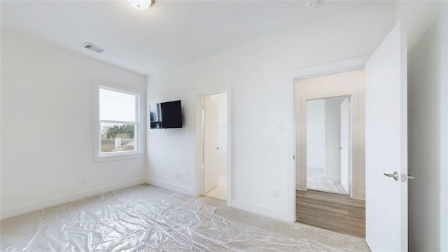 9616 Habitat St, Houston, TX 77075 - unfurnished bedroom featuring baseboards, ensuite bathroom, and visible vents