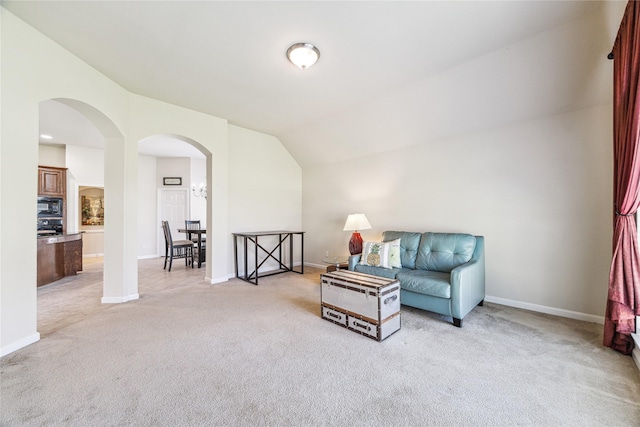 2230 Dali Ln, Missouri City, TX 77459 - living area featuring baseboards, arched walkways, light colored carpet, and lofted ceiling