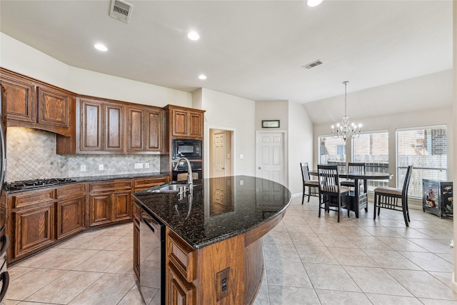2230 Dali Ln, Missouri City, TX 77459 - kitchen featuring light tile patterned floors, a notable chandelier, a sink, gas stovetop, and black microwave