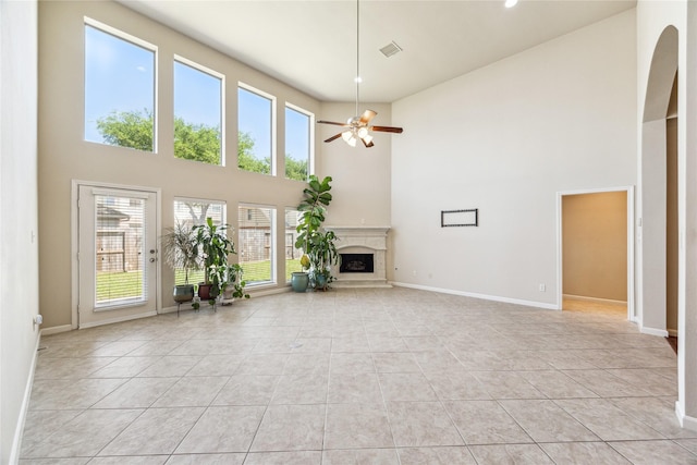 2230 Dali Ln, Missouri City, TX 77459 - unfurnished living room with ceiling fan, baseboards, a fireplace with raised hearth, and light tile patterned floors