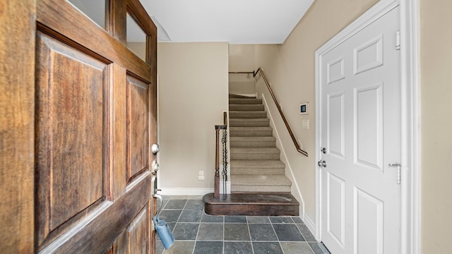 staircase with tile patterned floors and baseboards