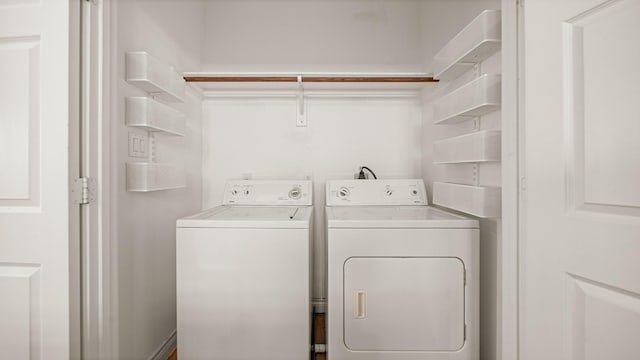 clothes washing area with washing machine and clothes dryer and laundry area