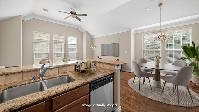 kitchen with vaulted ceiling, crown molding, a sink, dishwasher, and visible vents