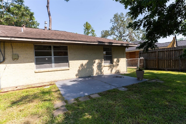 2315 Poinciana Dr, Houston, TX 77018 - rear view of property featuring brick siding, a patio, fence, and a lawn