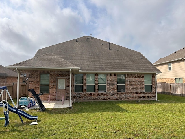 20334 Fossil Valley Ln, Cypress, TX 77433 - back of house with a yard, brick siding, a patio area, a shingled roof, and a fenced backyard