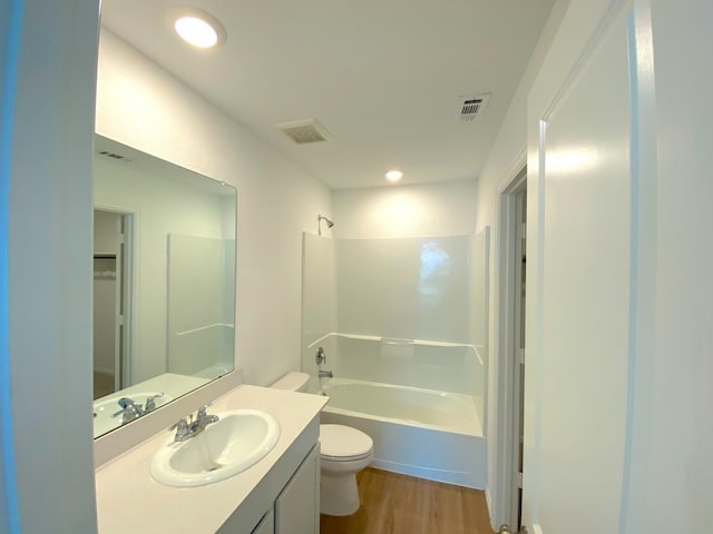 21015 Longeni Dr, New Caney, TX 77357 - full bathroom featuring toilet, tub / shower combination, wood finished floors, vanity, and recessed lighting